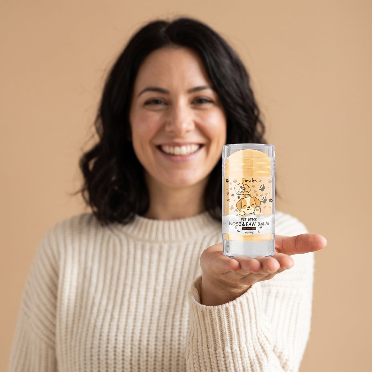 Woman holding the Pawdys paw balm stick