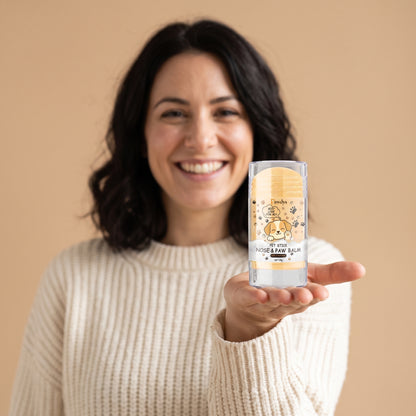 Woman holding the Pawdys paw balm stick